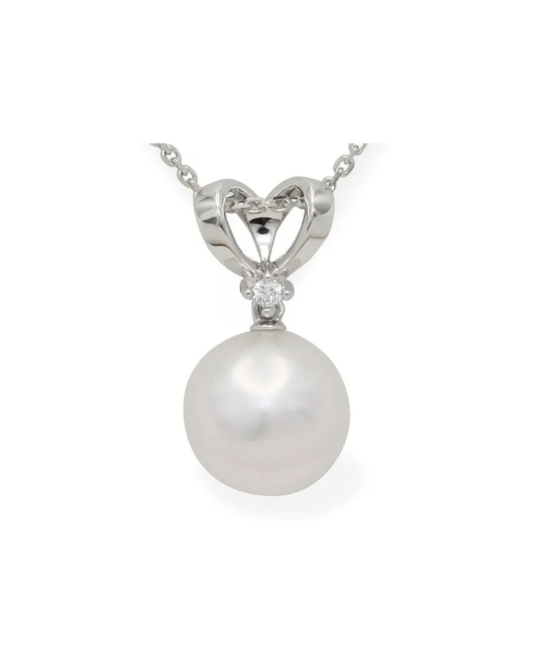 A silver necklace pendant featuring a single lustrous white pearl topped with a small diamond, set in a heart-shaped bale.