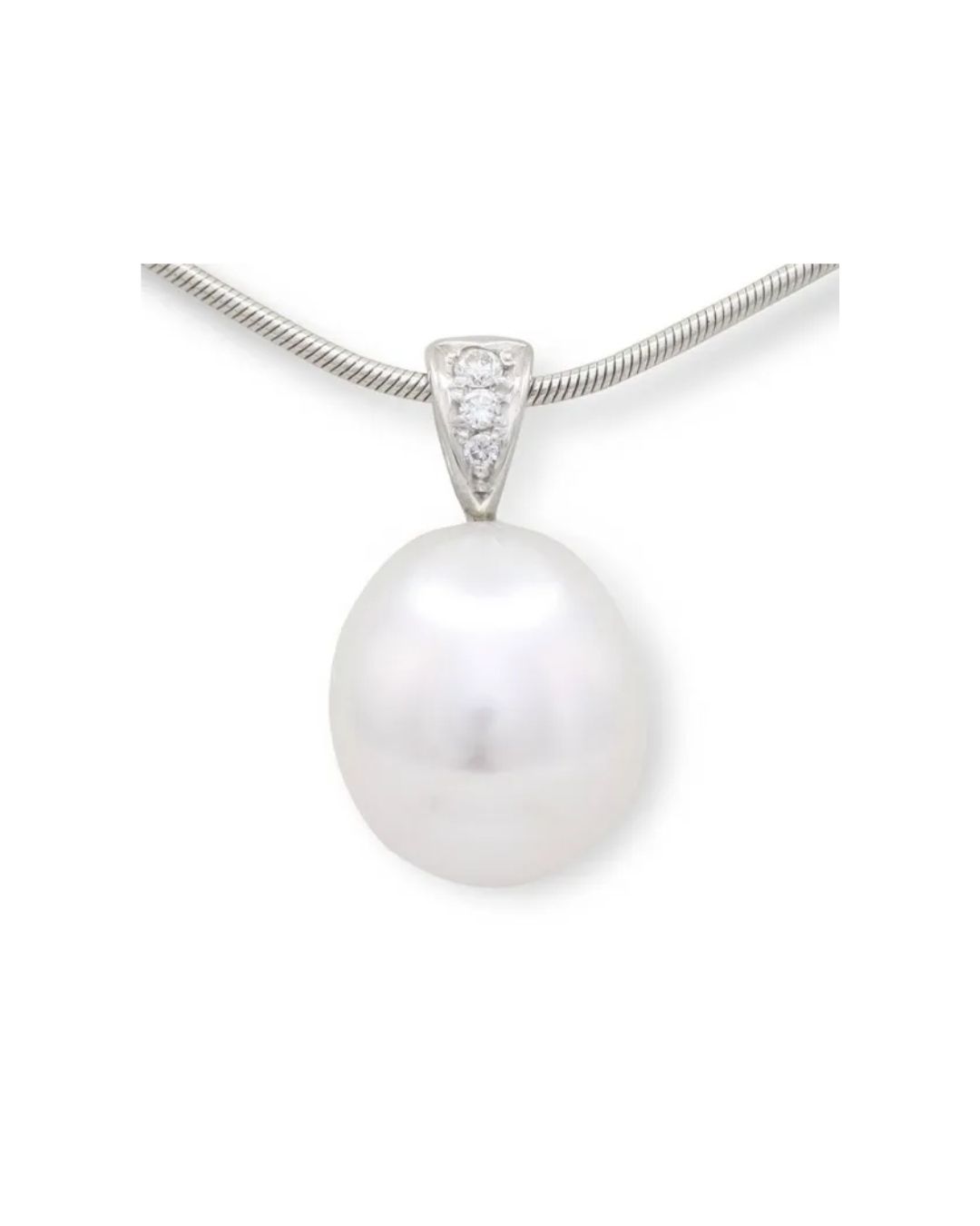 A large, white, teardrop-shaped pearl pendant set on a silver bail with three small diamonds, hanging on a silver chain.