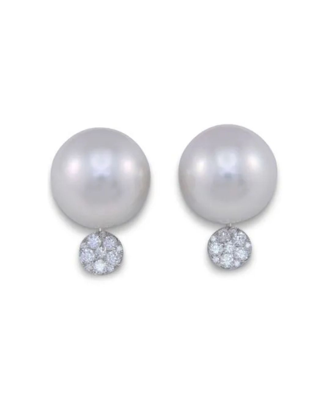 A pair of silver-toned stud earrings featuring a large pearl suspended above a circular cluster of diamonds.
