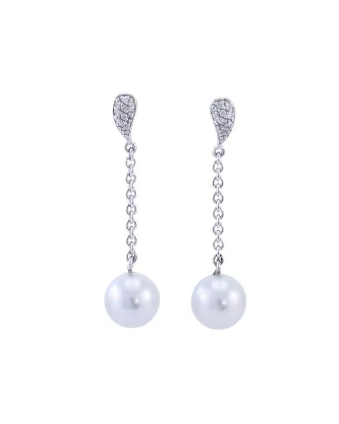 A pair of silver drop earrings featuring diamond-encrusted tops hanging from thin chains to white spherical pearls.