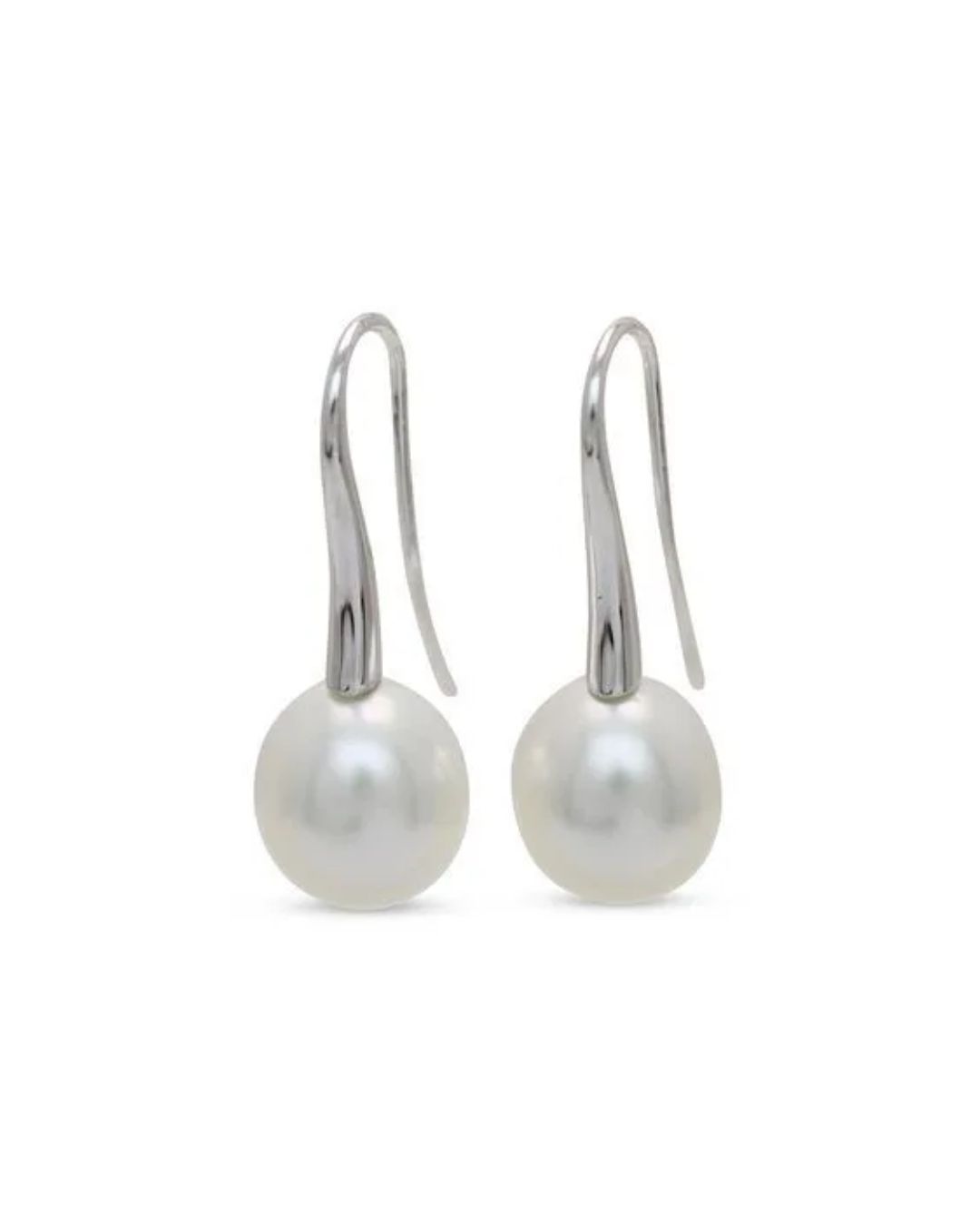 A pair of silver drop earrings featuring white spherical pearls on curved metal hooks against a white background.