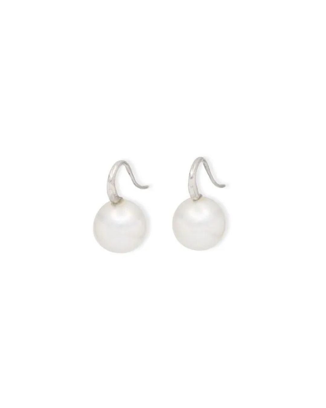 A pair of white pearl drop earrings with silver hook settings against a plain white background.