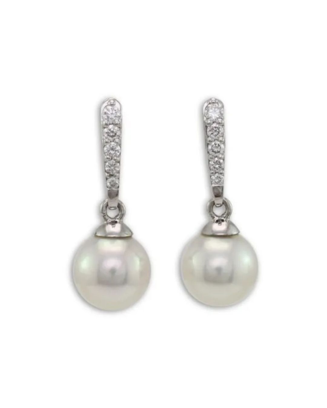 A pair of dangling earrings featuring white pearls suspended from silver hooks encrusted with small clear stones.