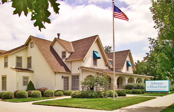 A johnson funeral home with an american flag in front of it