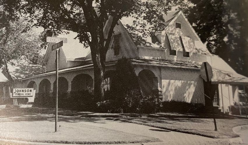 A black and white photo of a house that is being demolished