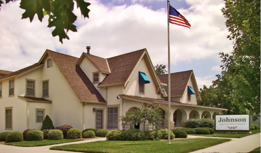 Johnson funeral home with a flag in front of it