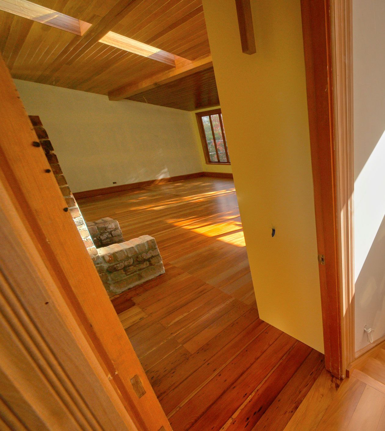 A room with hardwood floors and a chair in it