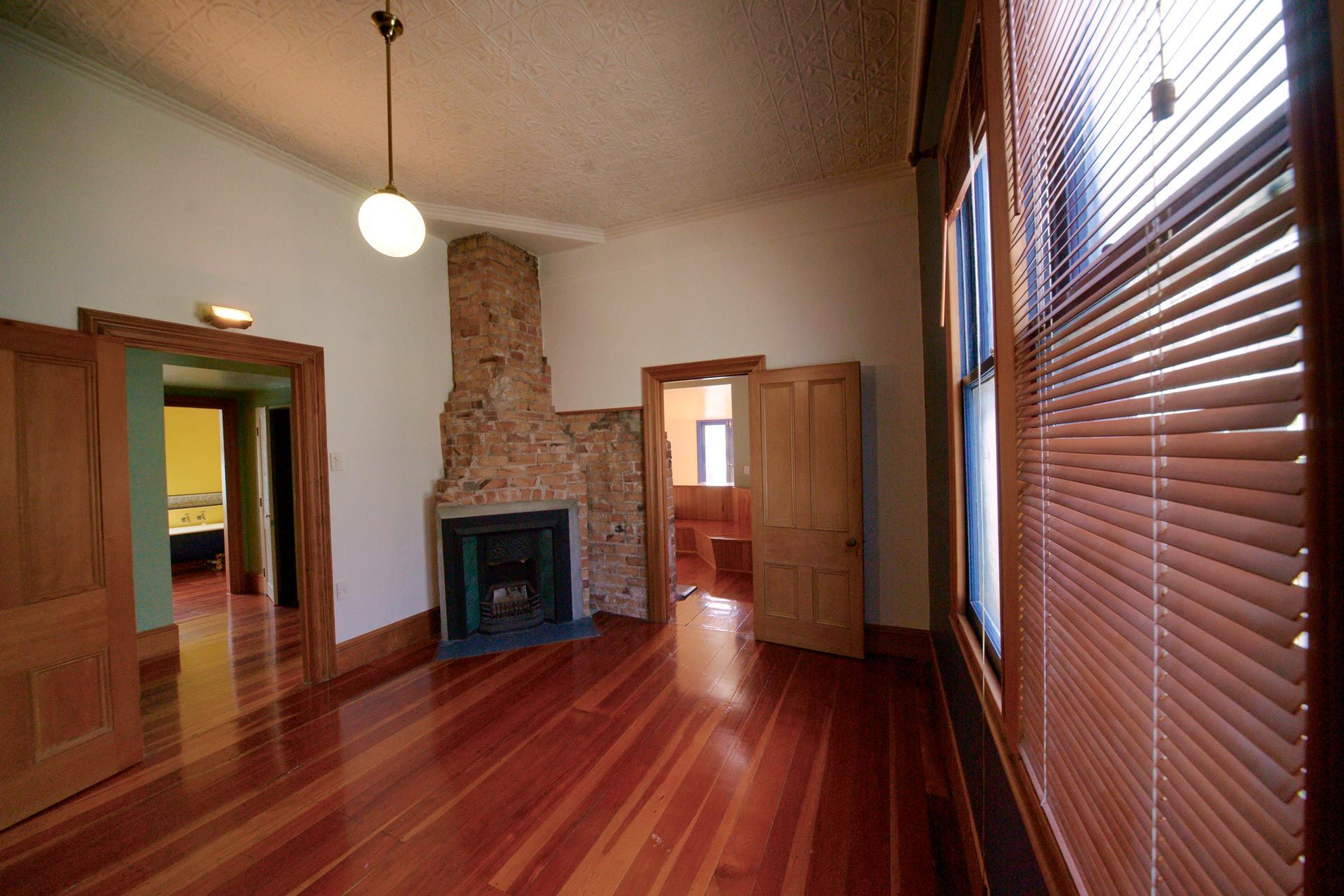 A living room with hardwood floors and white walls.