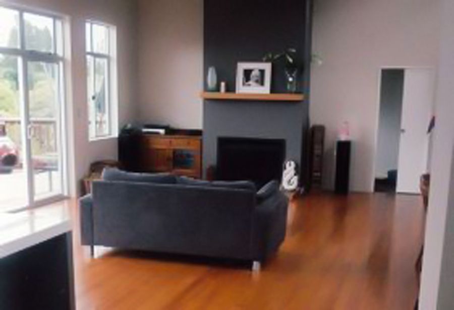 A living room with a fireplace and a couch