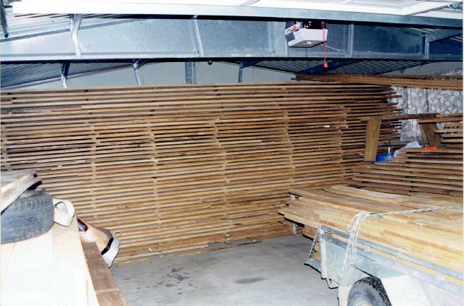 A room with a lot of wood stacked on top of each other