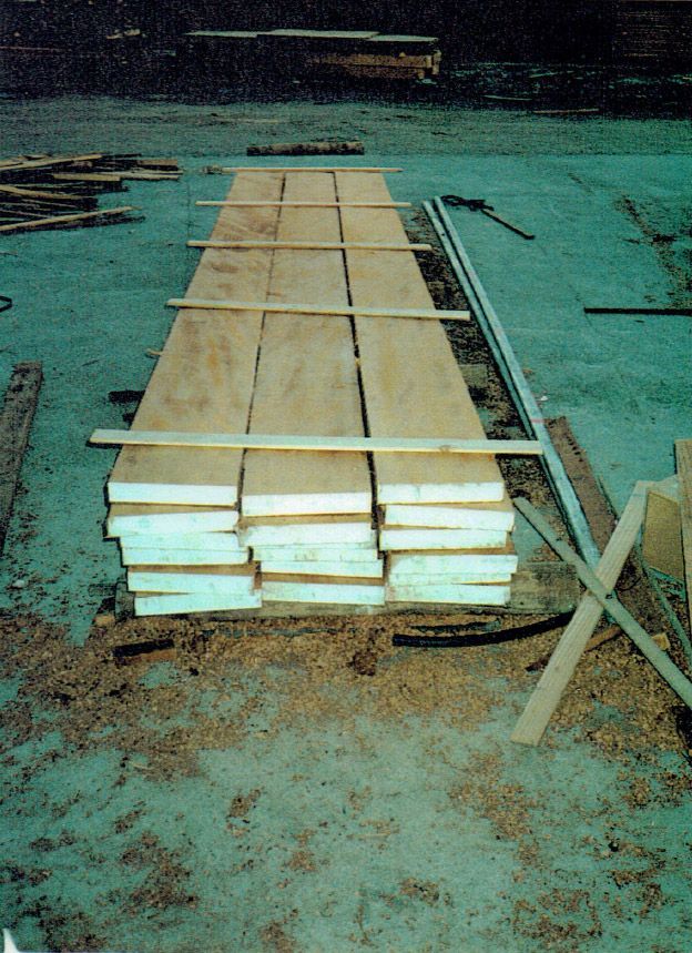 A stack of wood sitting on top of a concrete surface