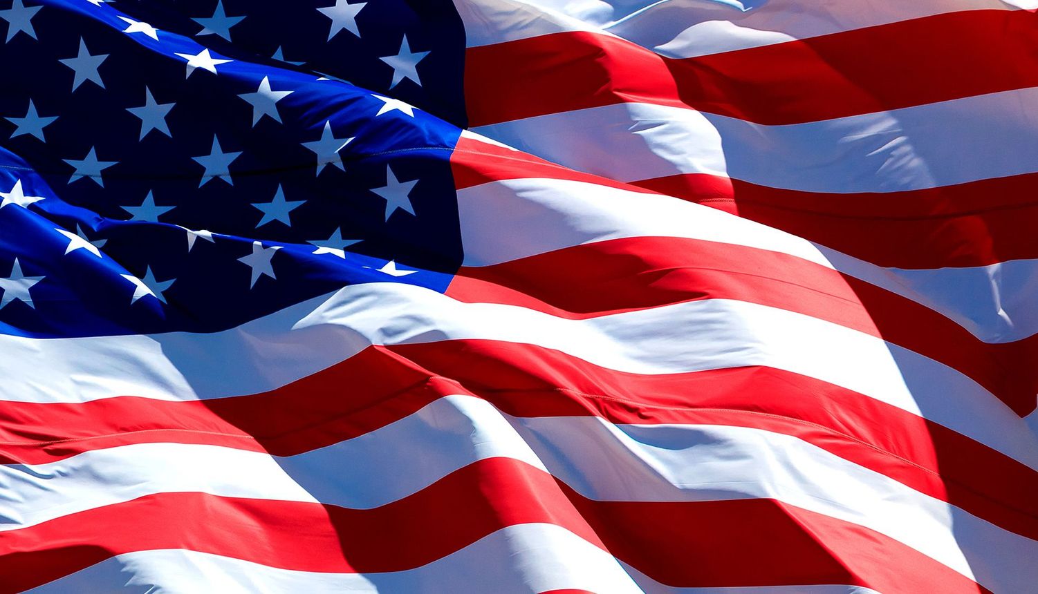 American flag waving, stars and stripes prominent.