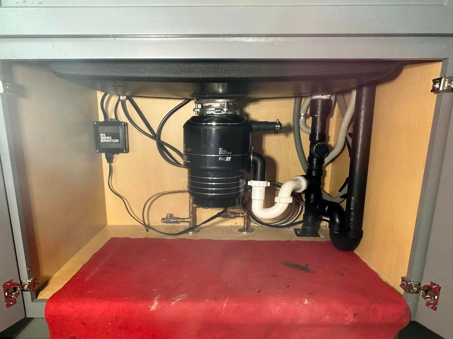 A sink with a garbage disposal underneath it