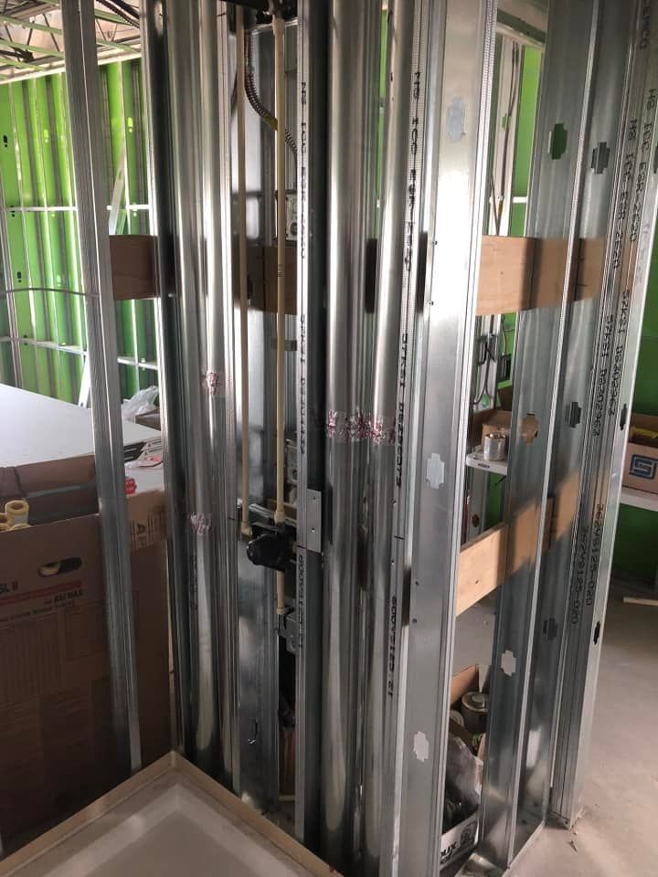 A room with a lot of metal walls and pipes in it.