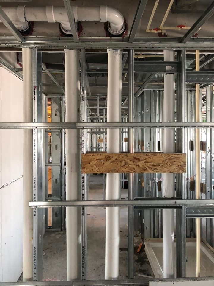 A building under construction with a lot of pipes
