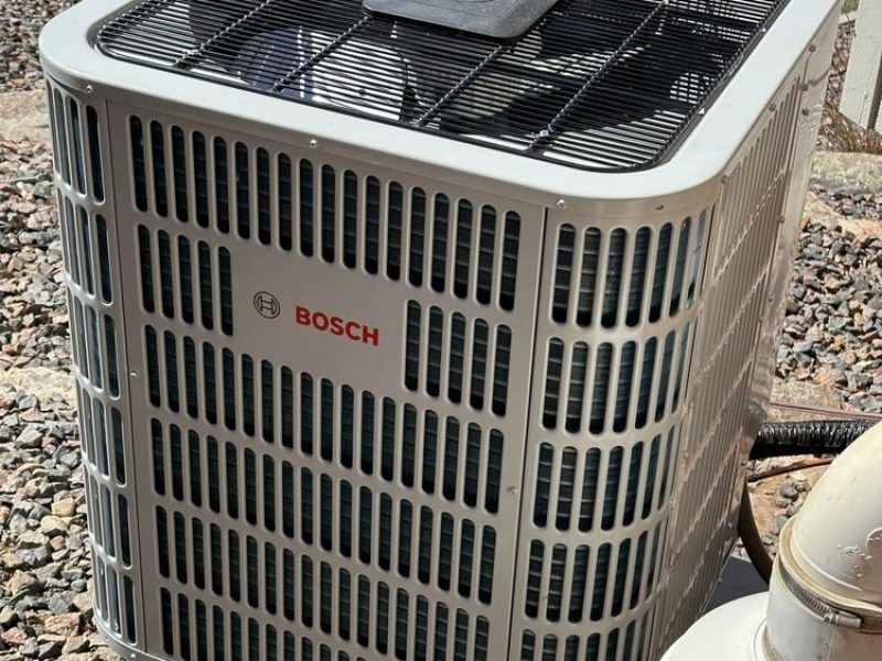 A bosch air conditioner is sitting on the ground