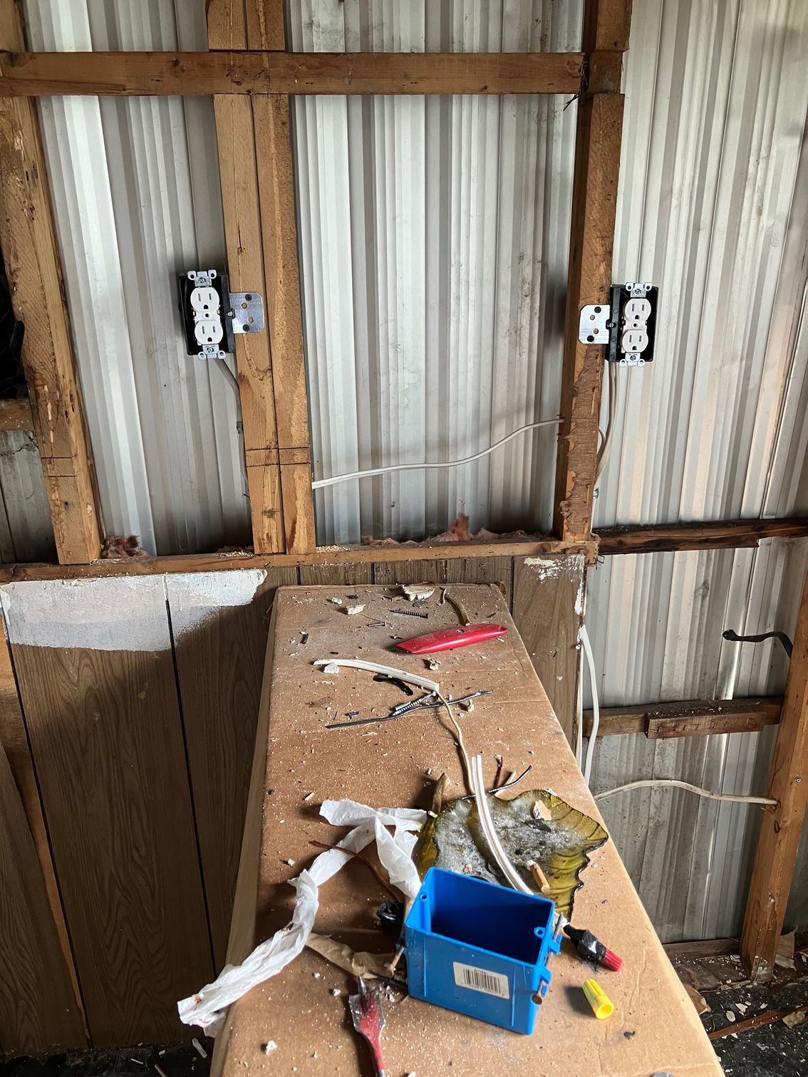 A wooden table with a blue box and tools on it.