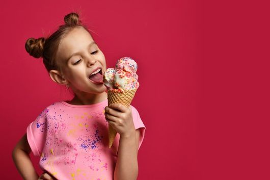 girl holding large ice cream cone