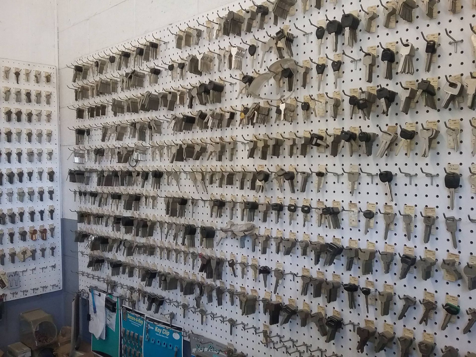 A bunch of keys are hanging on a wall