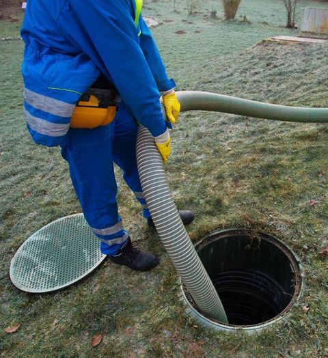 Man Cleaning the Septic — Appomattox, VA — Taylor’s Septic Service Inc