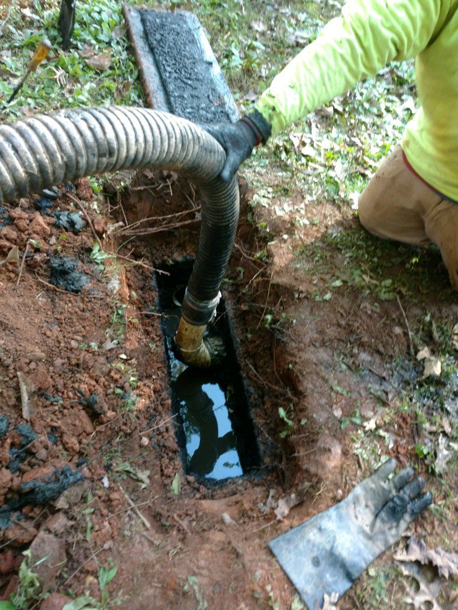 Man Working on Cleaning the Septic Tank — Appomattox, VA — Taylor’s Septic Service Inc