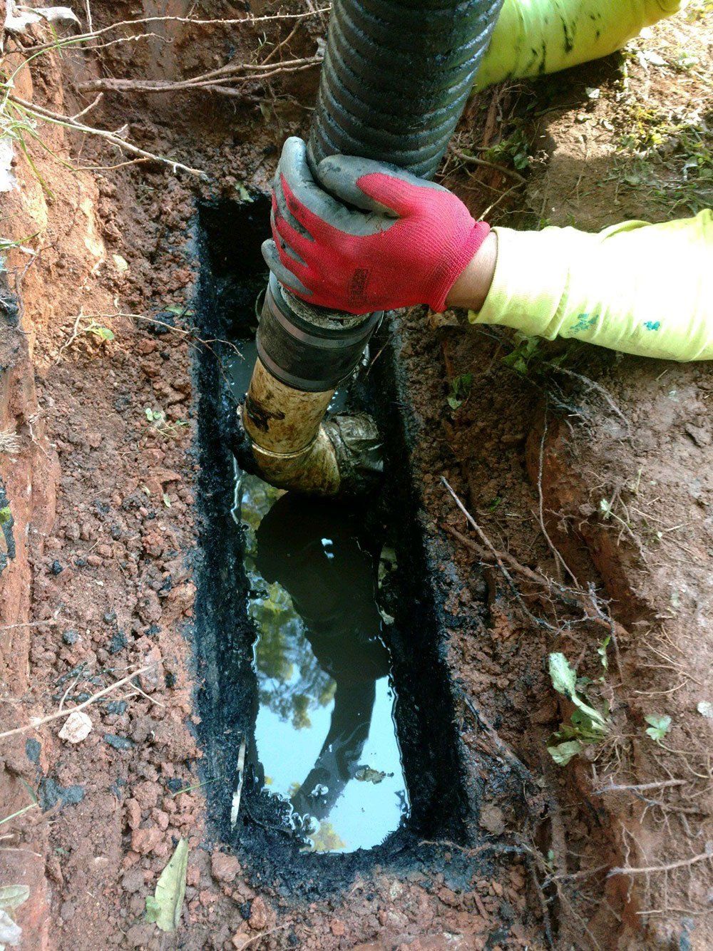 Worker Cleaning the Septic — Appomattox, VA — Taylor’s Septic Service Inc