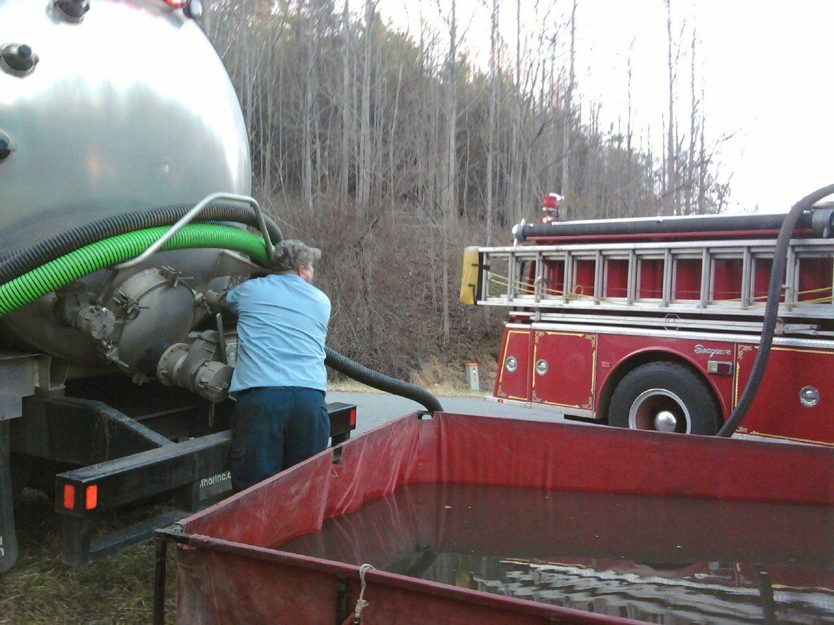 Man Checking the Septic Truck — Appomattox, VA — Taylor’s Septic Service Inc