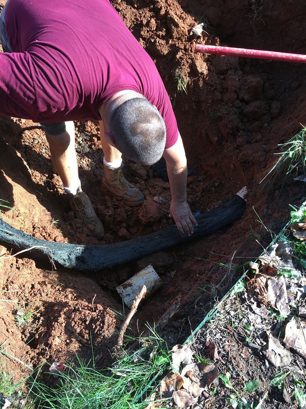 Man Checking the Pipe — Appomattox, VA — Taylor’s Septic Service Inc
