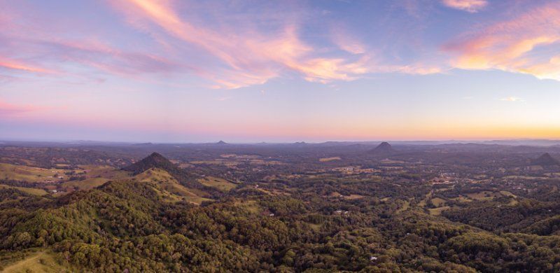 A Landscape With Mountains and Trees at Sunset — MDK Mini Excavator - Dingo & Tipper Hire in Sunshine Coast, QLD