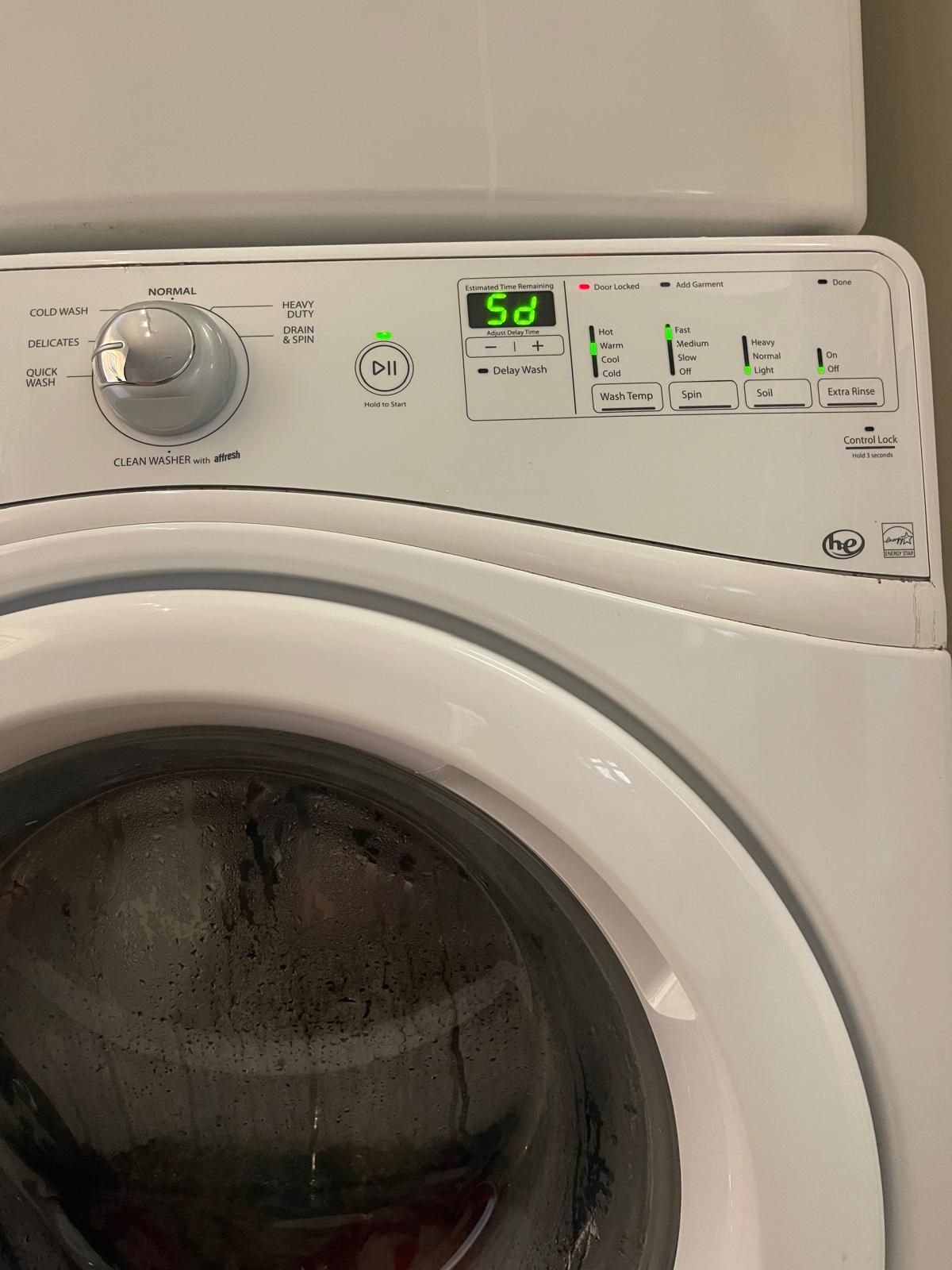 White washing machine control panel displaying