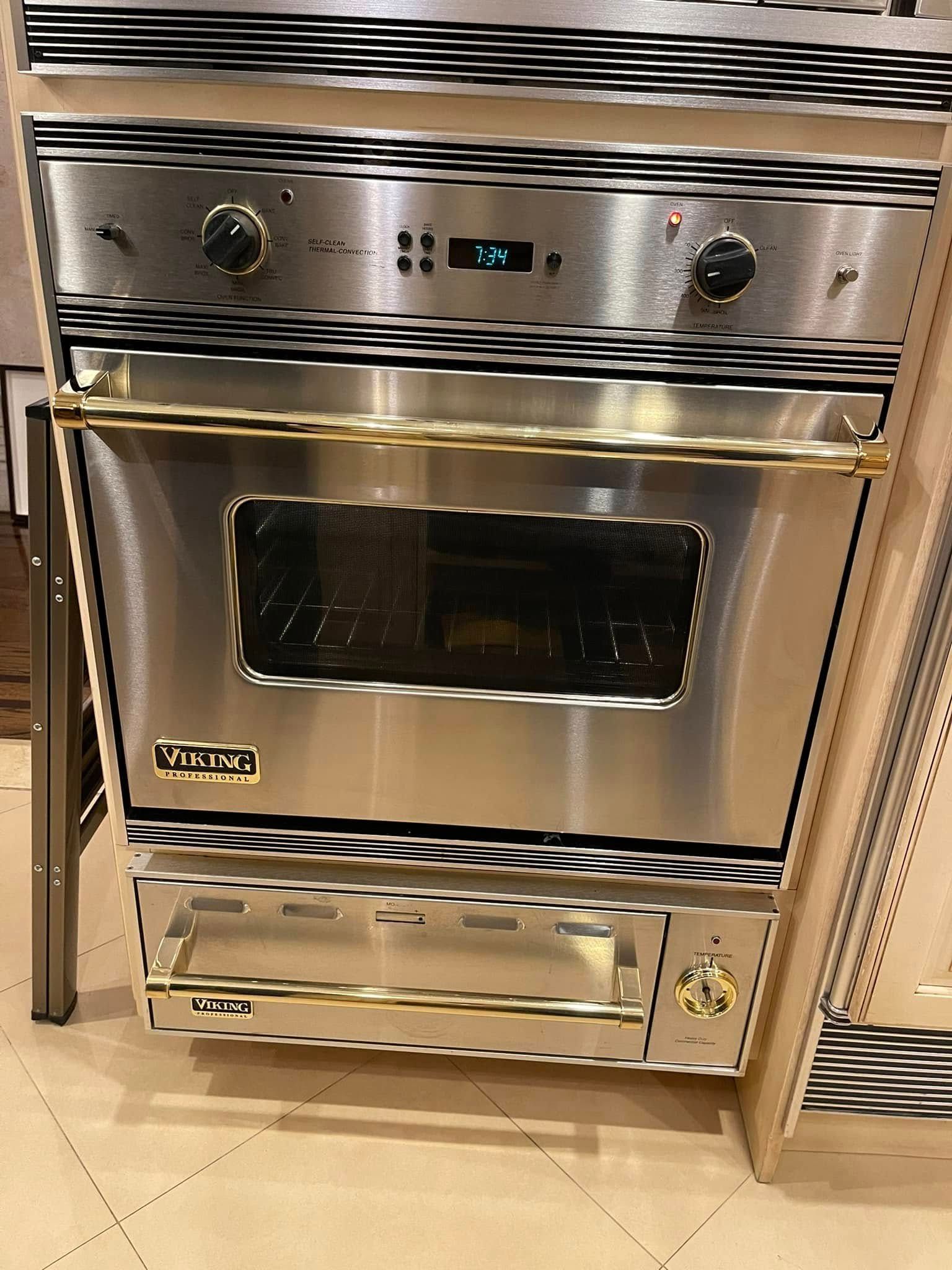 Stainless steel Viking oven with gold trim, knobs and digital display.