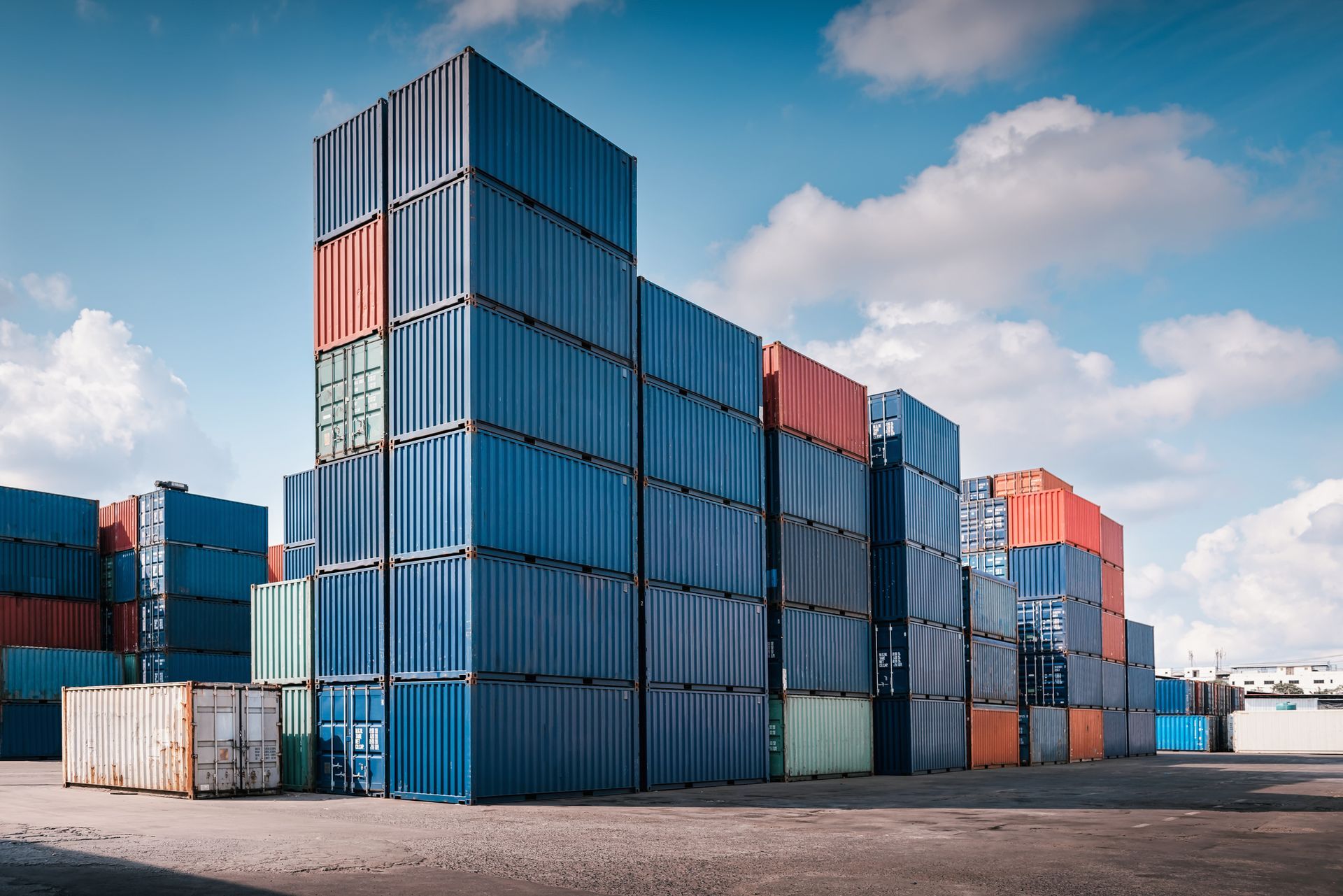 Row of clean, secure storage containers stacked outdoors.