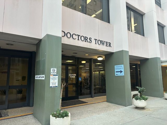 Outside of a large building that says 