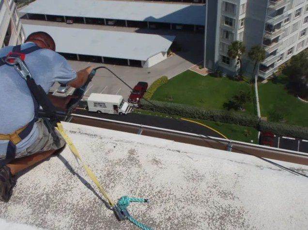 Man Installing Gutter On Building — Oakland Park, FL — Watertite Gutter Company
