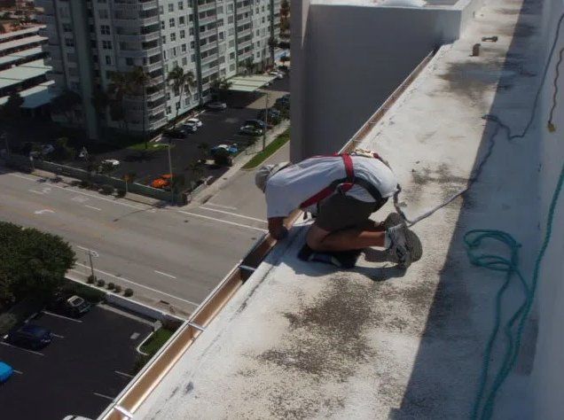 Man Working On Commercial Gutter — Oakland Park, FL — Watertite Gutter Company