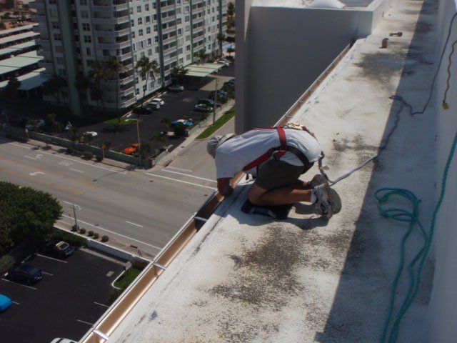 Man Working On Commercial Gutter — Oakland Park, FL — Watertite Gutter Company