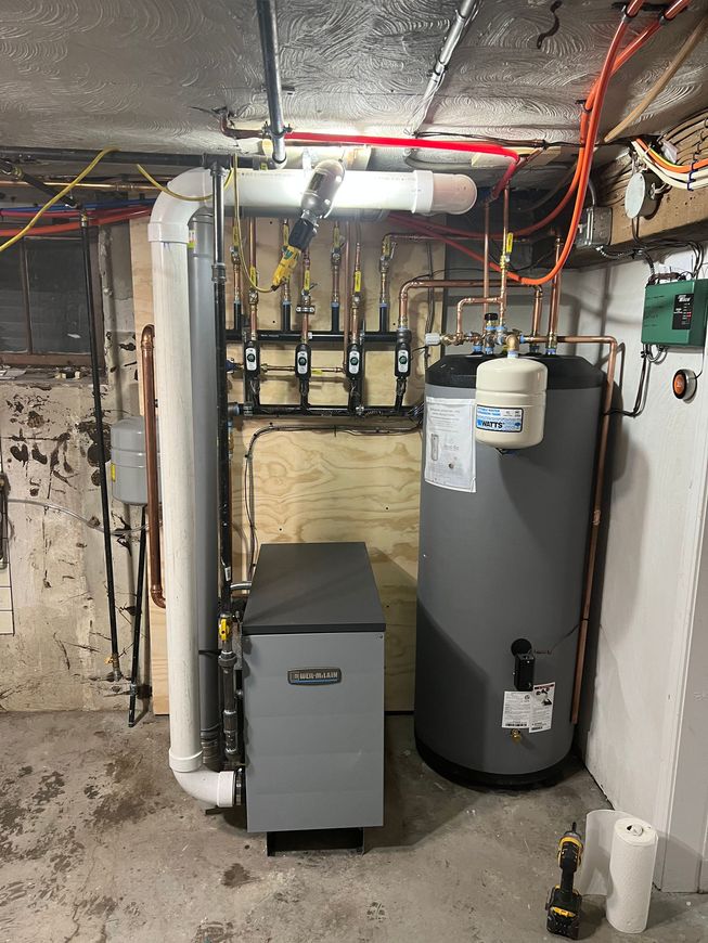 boiler installation quincy ma A newly installed boiler and a water heater in a basement in Quincy MA