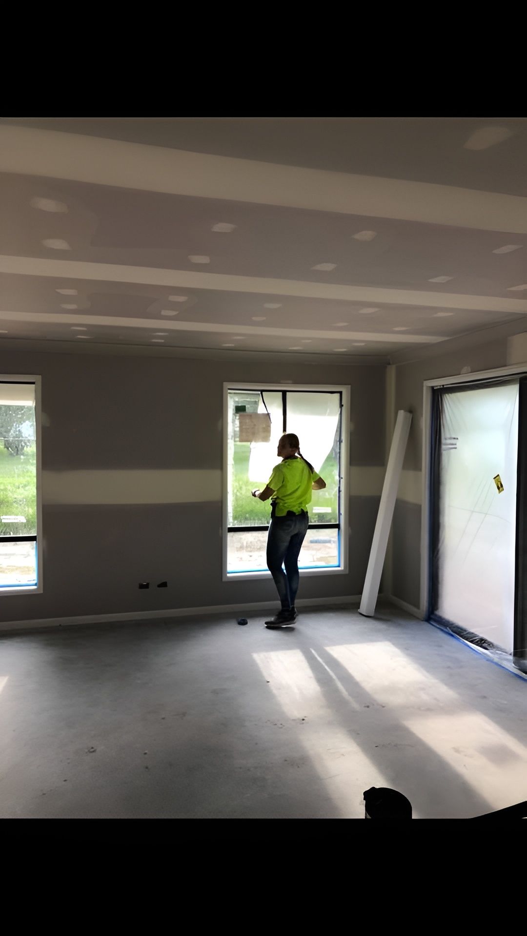 Construction Worker In Hi-vis Vest Inspecting A Window — Allman's Painting in Sunshine Coast, QLD