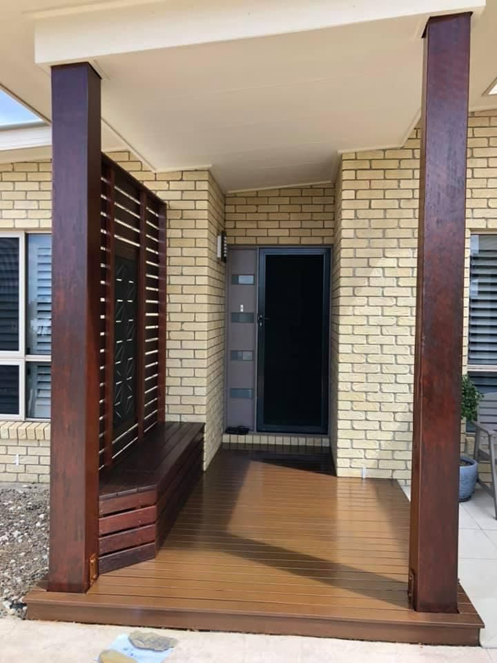 A Brick House with A Wooden Porch and A Bench — Allman's Painting in Monkland, QLD