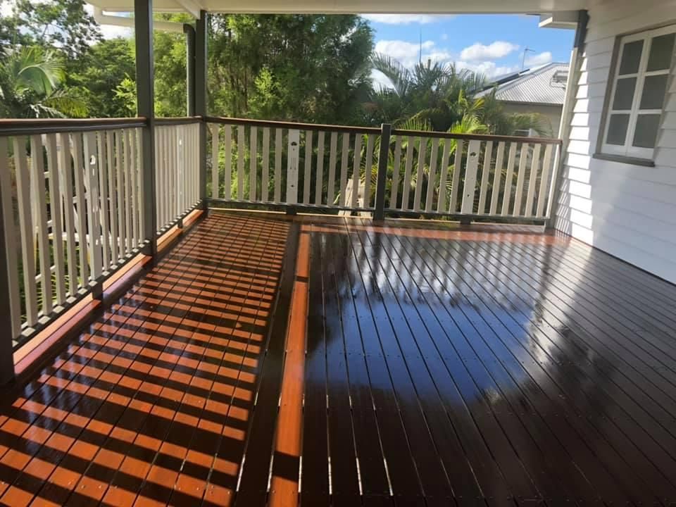 A Porch with A Wooden Deck and A White Railing — Allman's Painting in Monkland, QLD