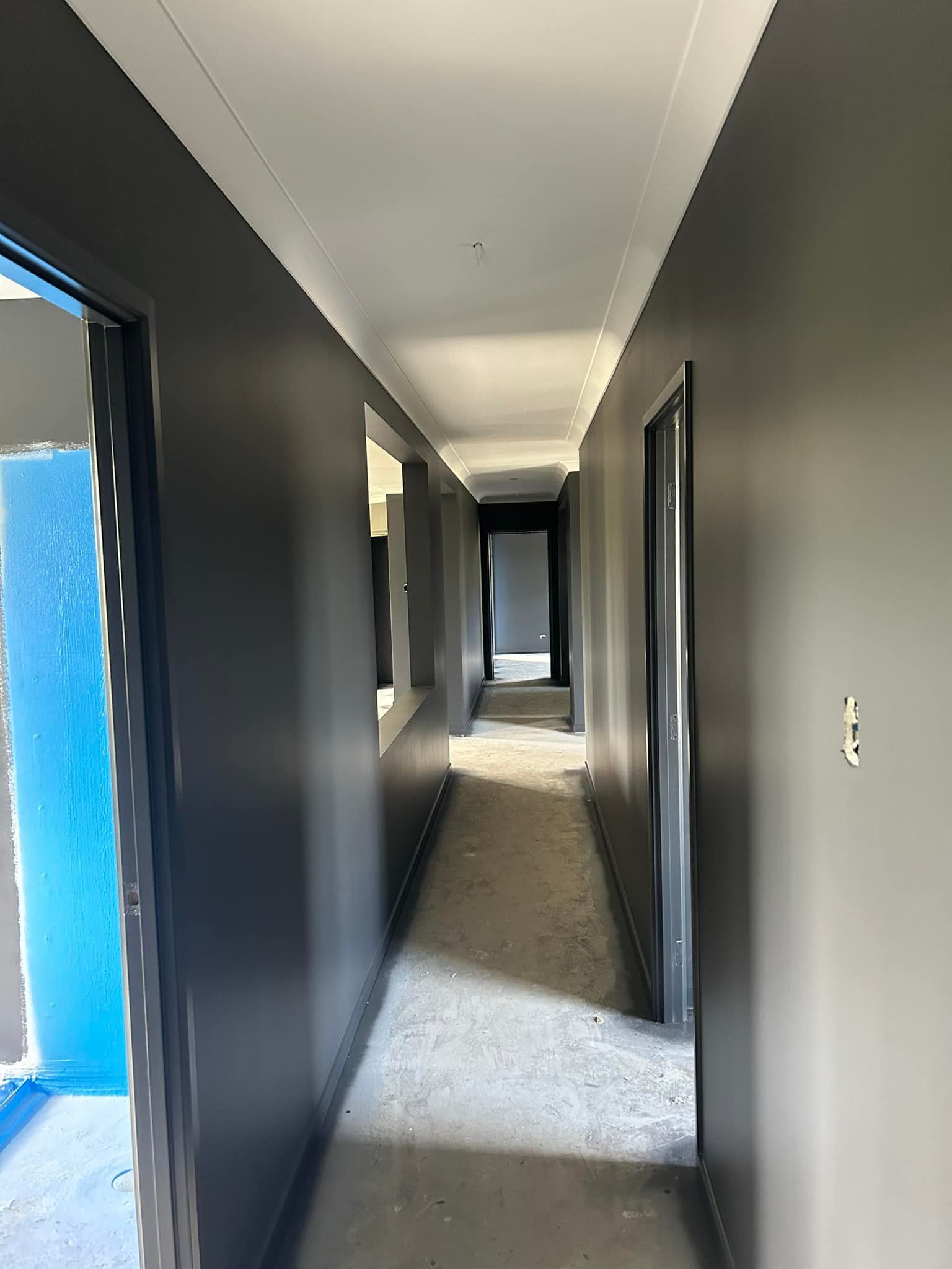 Narrow Hallway With Dark Gray Walls, White Ceiling, And Open Doorways — Allman's Painting in Noosa, QLD