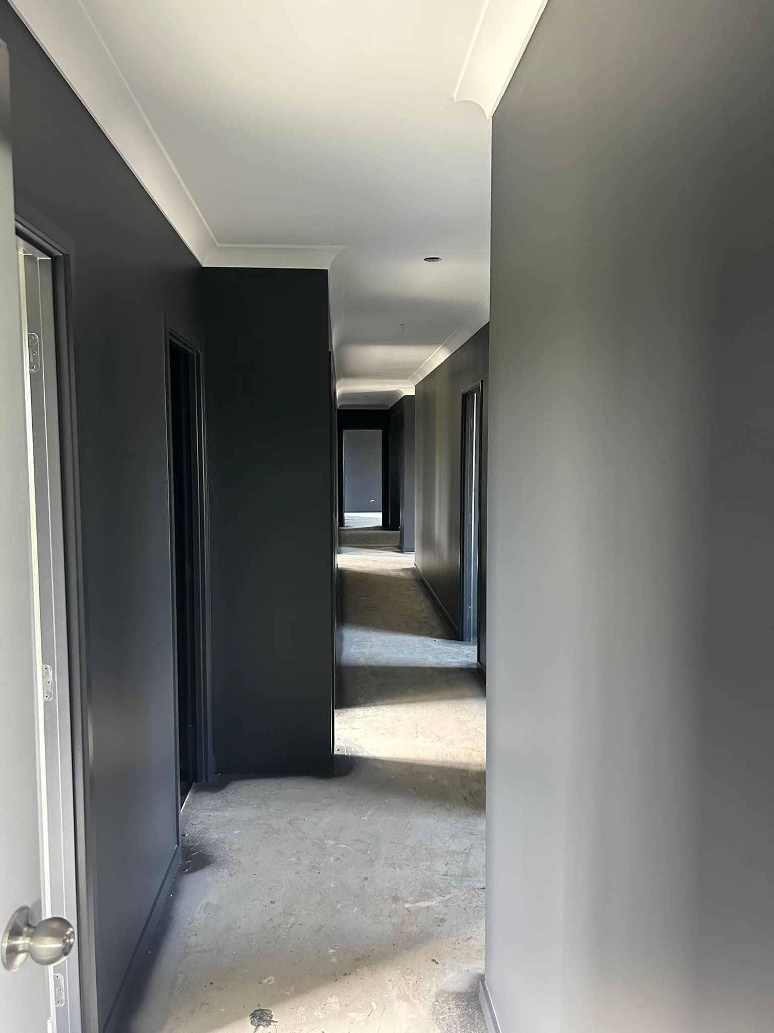 Long, Narrow Hallway Painted Dark Gray, With Doors On Both Sides — Allman's Painting in Noosa, QLD