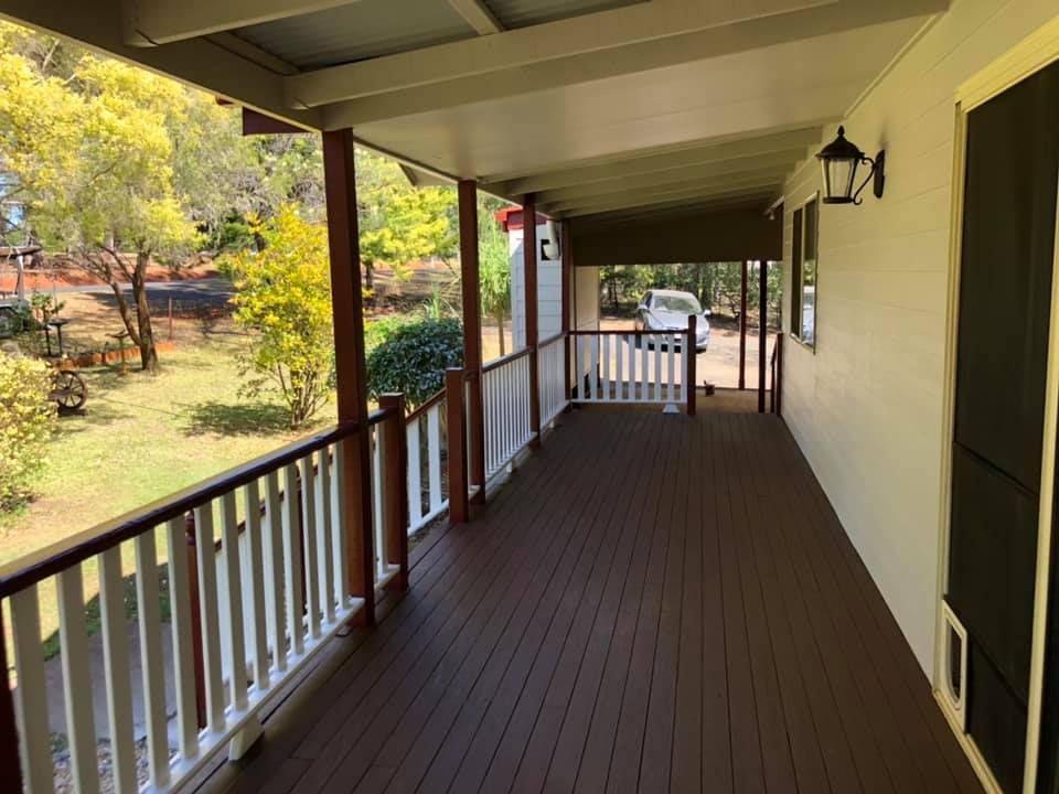 Covered Porch With Dark Wood Deck — Allman's Painting in Cooroy, QLD