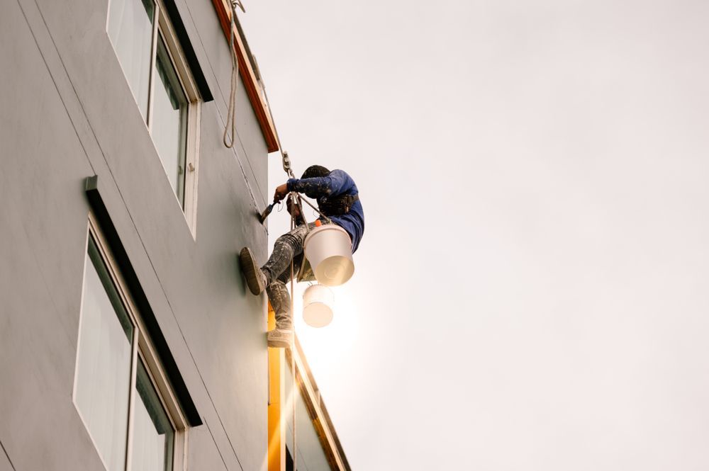 Construction Worker Painting Exterior of a Building — Allman's Painting in Noosa, QLD
