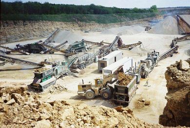 Blasted Rock — A Bulldozer With Two Red Cars in Janesville, WI