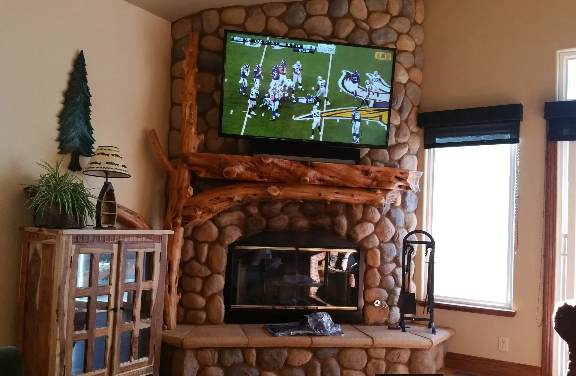 A living room with a fireplace and a flat screen tv