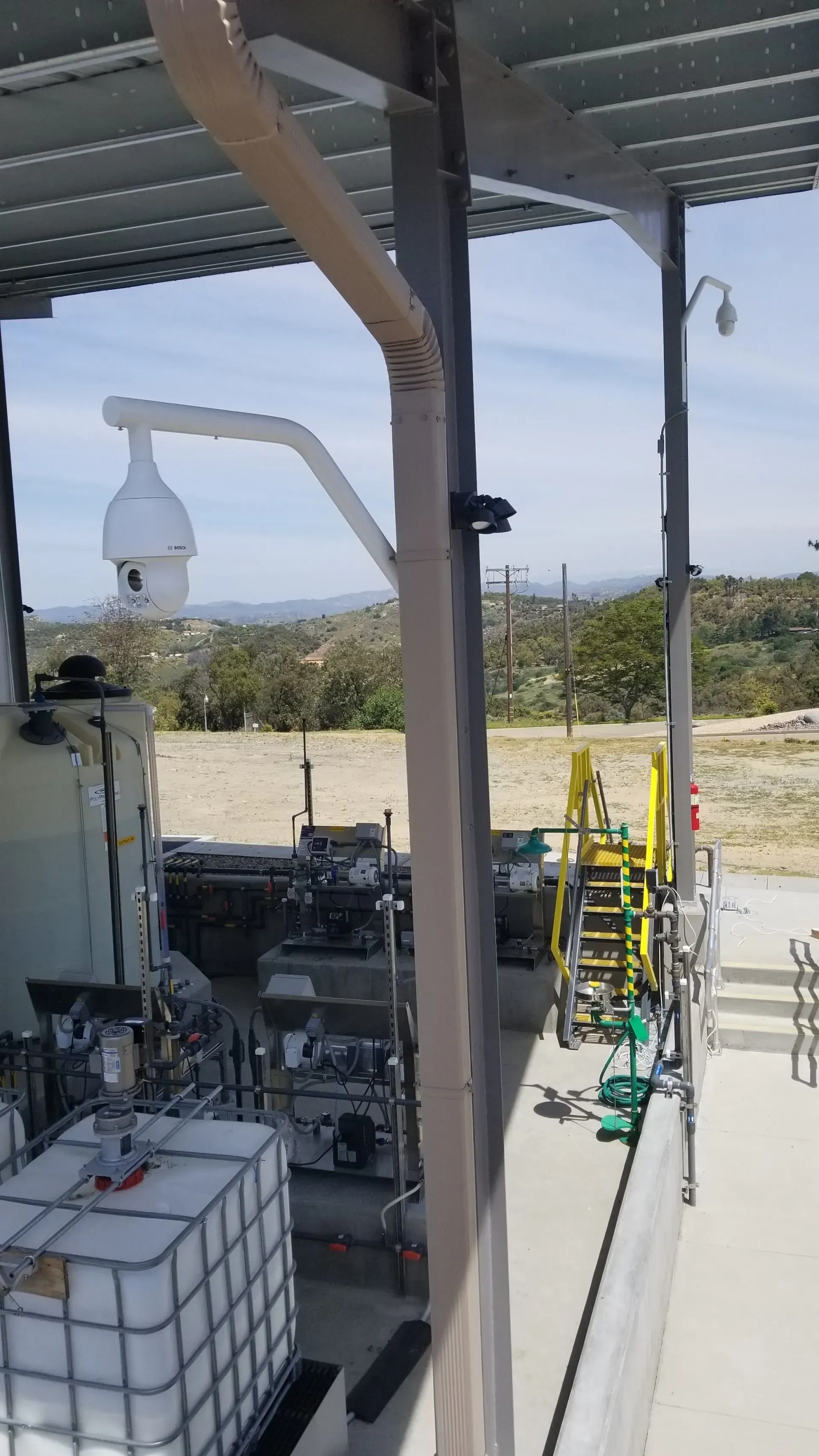 A warehouse with a lot of containers and a roof.
