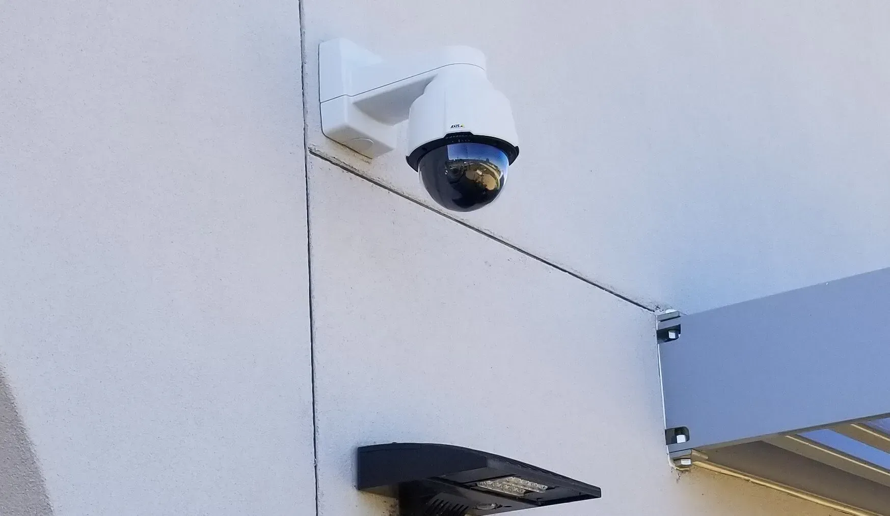 A security camera is mounted on the side of a building.