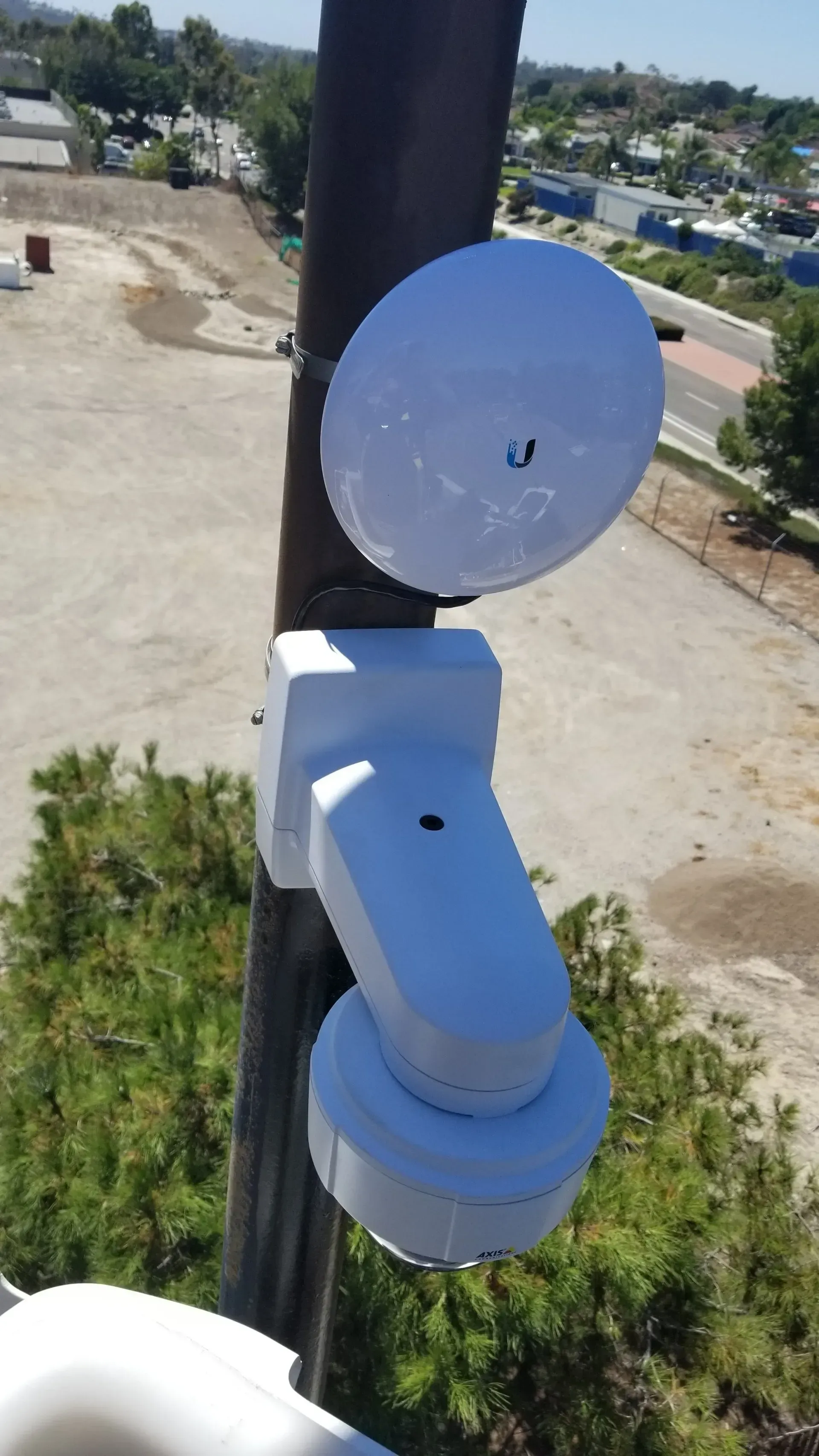 A couple of white boxes sitting on top of a pole.