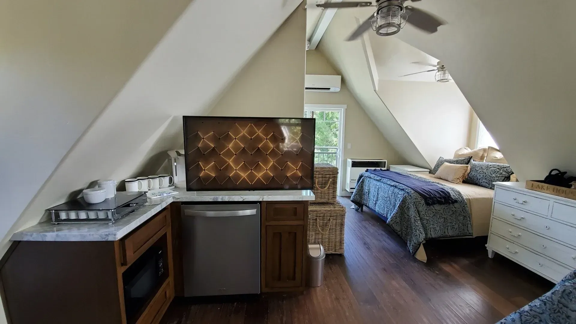 A bedroom with two beds and a flat screen tv